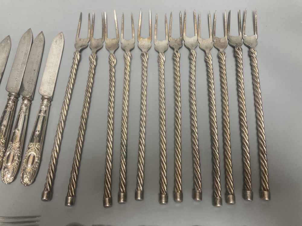 Twelve plated toasting forks and a set of six Victorian Elkington Mason & Co plated dessert knives and forks